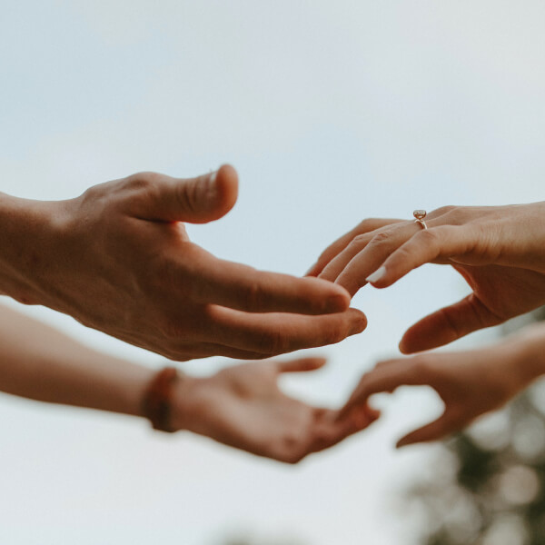 Two individuals joining hands. The joining of hands represents Linnea’s commitment to you and your business through cannabinoid API manufacturing, GACP compliance, and sustainability.